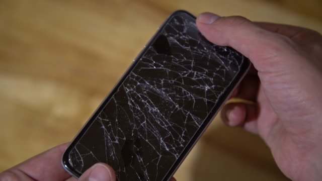 touching a phone with a cracked screen